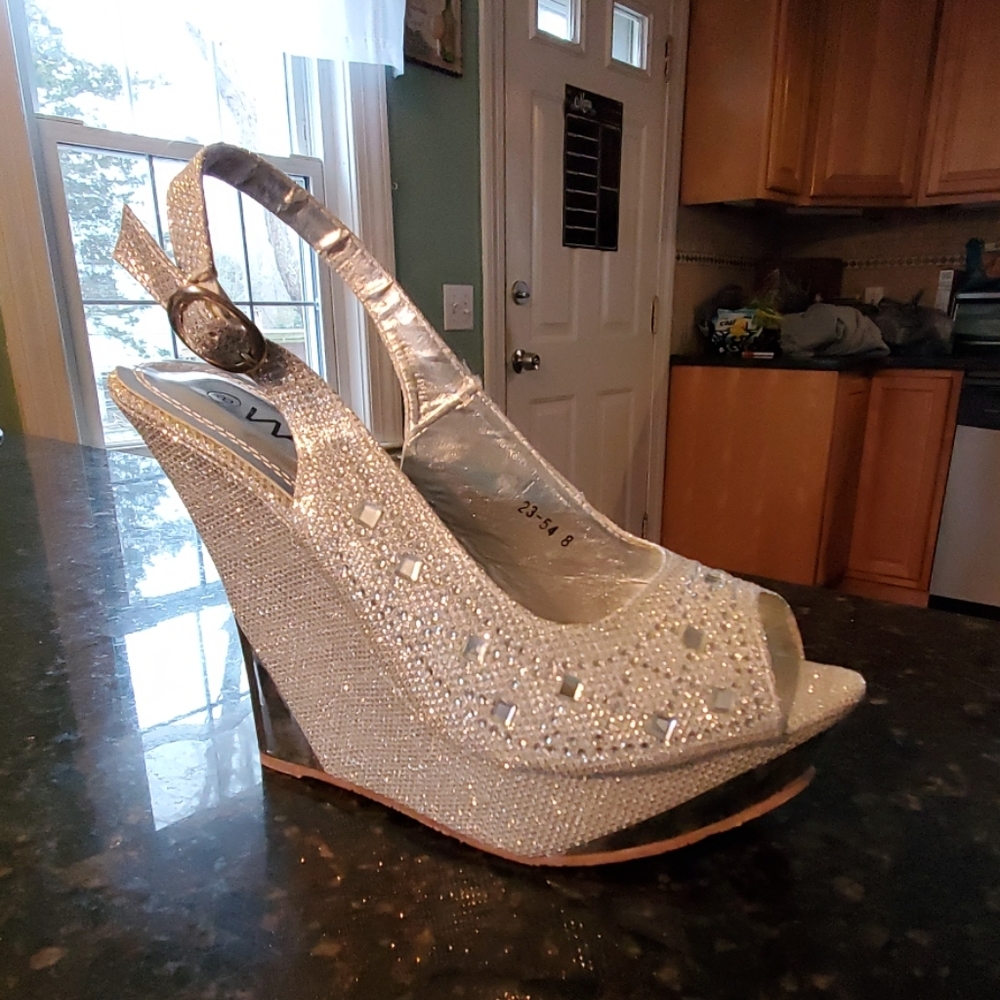 Silver size 8 never worn wedge heels.